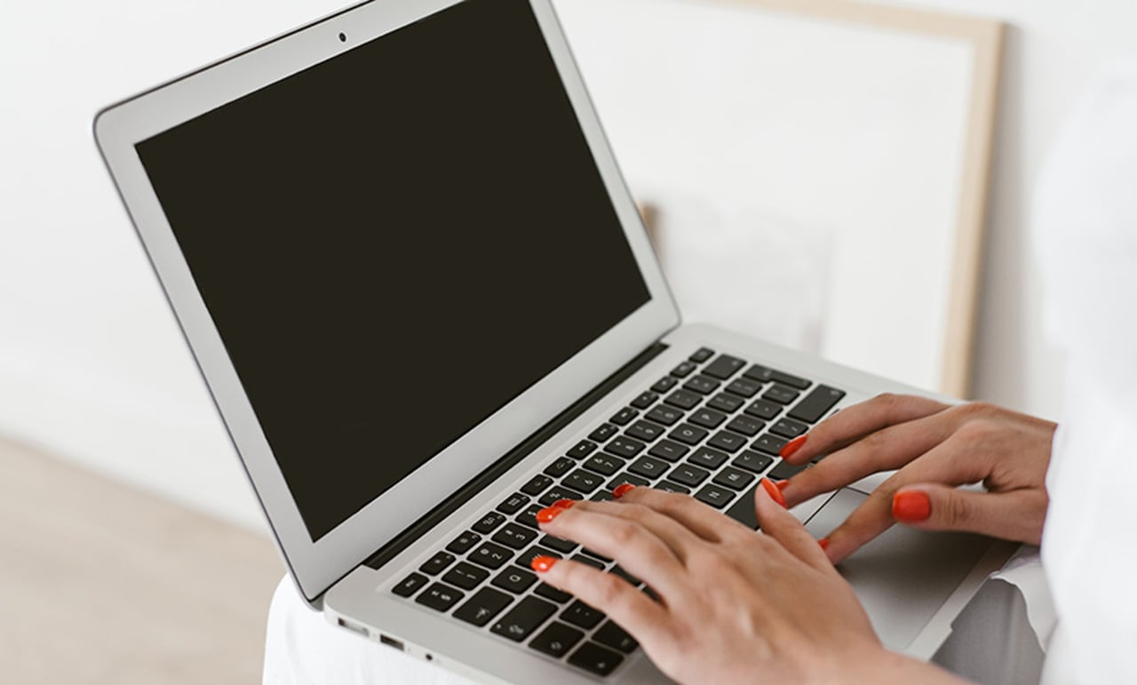 Captivating Customers Through Conversation: How CPaaS Creates a Truly Omnichannel CX Woman Working With Laptop On Knees