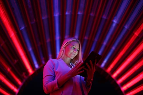 Businesswoman with tablet pc against high tech lights background