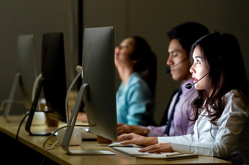 Call Center agents with headsets working in a call center at night